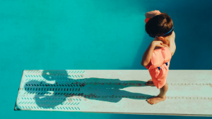 Photo of a boy waiting to jump in swimming pool